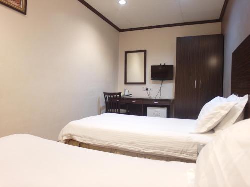 Postel nebo postele na pokoji v ubytování New City Hotel
