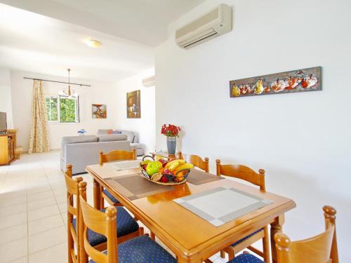 a dining room with a table with a bowl of fruit on it at Villa Afroditi, Spartia, Kefalonia in Kefallonia