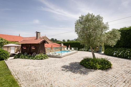 a house with a tent and a swimming pool at Casa de Ferreira Cinfães in Cinfães