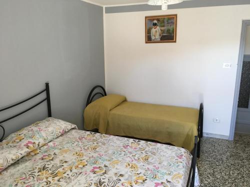 Кровать или кровати в номере Casa „Pizzuti“