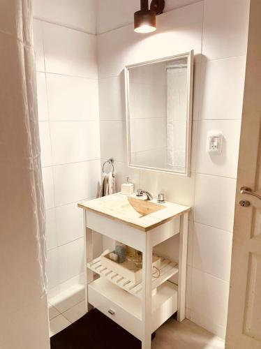 a bathroom with a sink and a mirror at La quinta de Vito in San Pedro