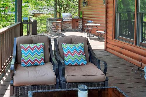 two chairs sitting on the porch of a cabin at Hayesville Cabin with Game Room and Mtn Views! in Hayesville