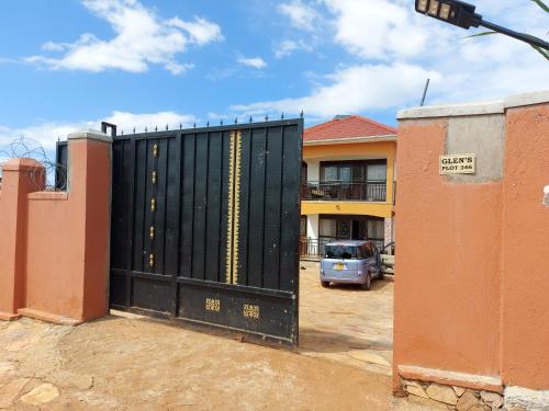 a large black gate in front of a building at Glen's Apartment in Entebbe