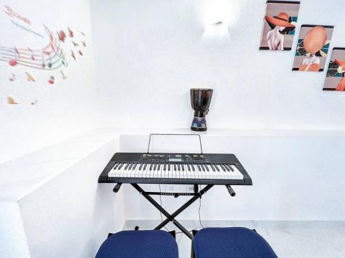 a keyboard on a table in a room with two chairs at Villa Bel Amour, luxury and awesome sea view in Upper Prince's Quarter