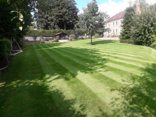a large lawn in front of a house at Riverside House in York