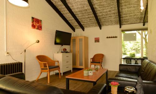 a living room with a couch and a table at Vakantie Zuid Limburg in Simpelveld