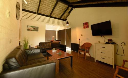 a living room with a couch and a table at Vakantie Zuid Limburg in Simpelveld