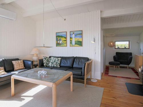 a living room with a couch and a table at 6 person holiday home in Gedser in Gedser