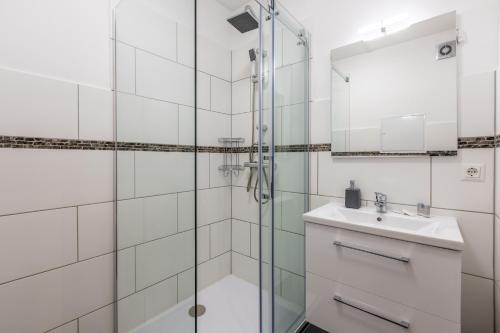 a bathroom with a glass shower and a sink at Munich Home in Munich