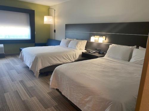 a hotel room with two beds and a window at Holiday Inn Express & Suites Warrensburg North by IHG in Warrensburg