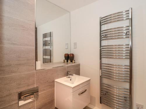 a bathroom with a toilet and a sink and a mirror at Flat 2 in Bournemouth