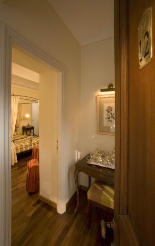 a room with a room with a bed and a table at Marcarini Agriturismo in Neviglie