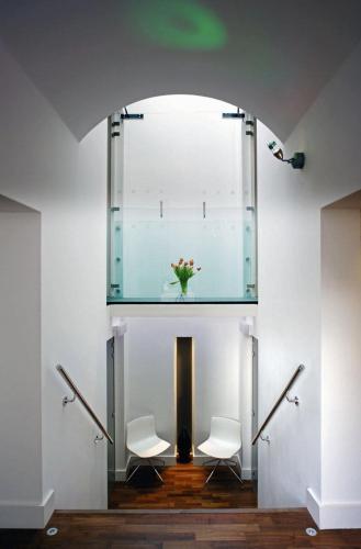 a room with two white chairs and a vase of flowers at B&B Belgravia in London