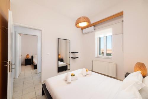 A bed or beds in a room at Aria apts 100 m from the beach by PosarelliVillas