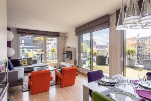 un salon avec une table et des chaises dans l'établissement ILLANKA - Appartement 3 chambres avec parking et terrasse proche gare, à Rennes