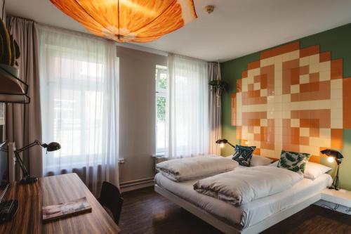 a living room with a couch in front of a window at Superbude Hamburg Altona in Hamburg