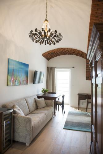 a living room with a couch and a table at Am Pfarrhof - Gourmethotel by Harald Irka in Sankt Andrä-Höch