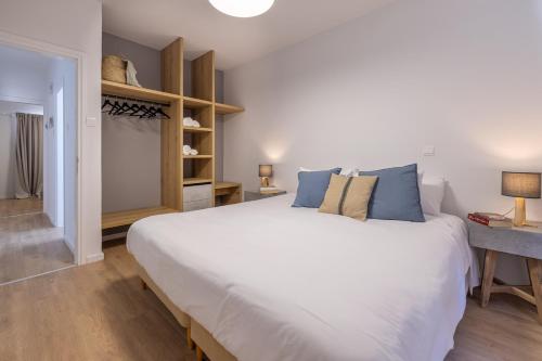 a bedroom with a large white bed and a desk at KSQUARED in Protaras