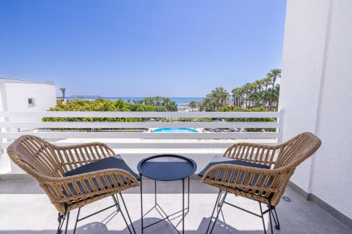 a patio with two chairs and a table on a balcony at KSQUARED in Protaras