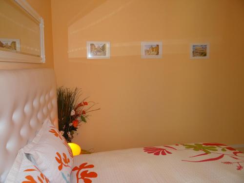 a bedroom with a bed and pictures on the wall at Orange Flower Apartments 1 in Sofia