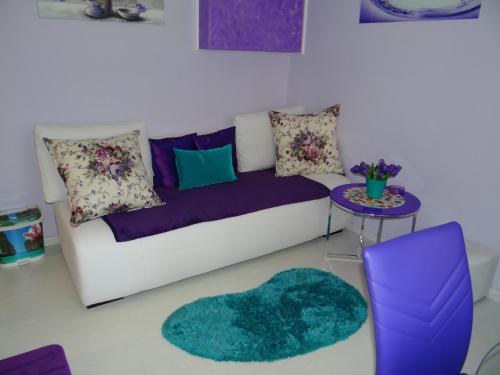 a living room with a couch and a table at Orange Flower Apartments 1 in Sofia