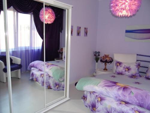 a room with two beds and a mirror at Orange Flower Apartments 1 in Sofia