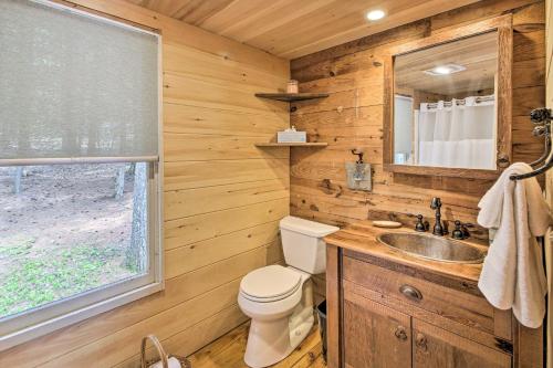 a bathroom with a toilet and a sink and a window at Lakefront Cottage Boat Dock, Patio and Kayaks! in Oxford