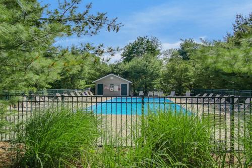 a small house next to a swimming pool at Kingfisher Cove Cabin 2 in Saugatuck