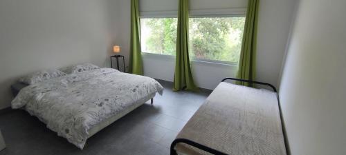 a bedroom with a bed and a window at Maison Pré Long et Pré Long House in Le Thoronet