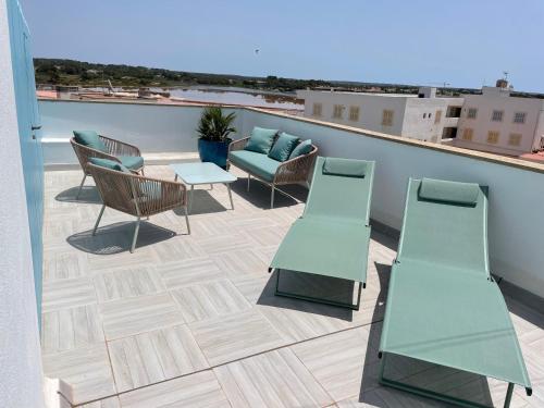 a patio with chairs and a table on a roof at Blue House Mallorca in Ses Salines