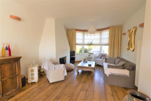 a living room with a couch and a table at Home sweet home in Breskens