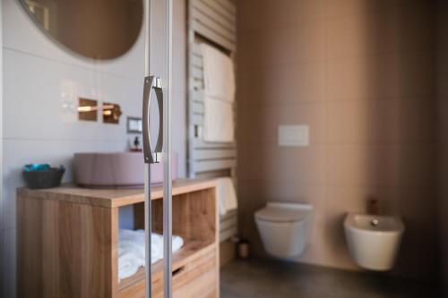 a bathroom with a sink and a toilet at LUXURY SUITES ROCOPOM - Lake Front in Lecco