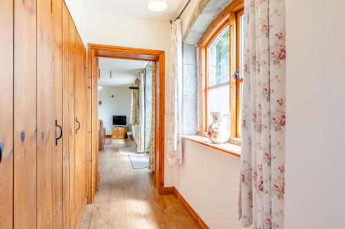 a hallway in a house with a window at Swallow's Nest in Craven Arms