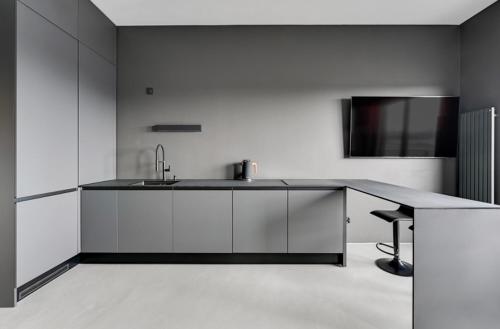 a kitchen with a counter with a sink and a table at Apartament Gdańsk Premium Lux Nadmotławie in Gdańsk