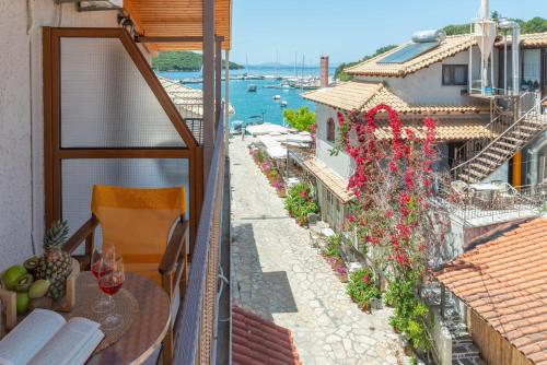 a balcony with a table and a view of the water at Virvilis Apartments in Sivota