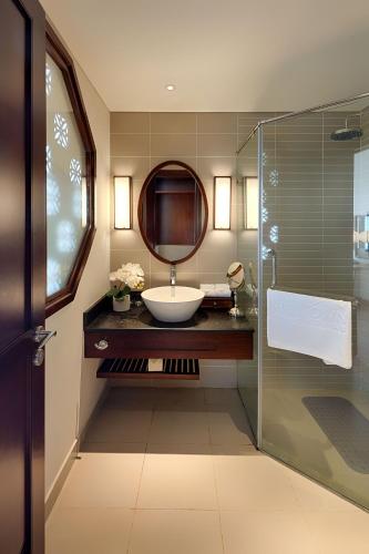 a bathroom with a sink and a mirror at RiverTown Hoi An Resort & Spa in Hoi An