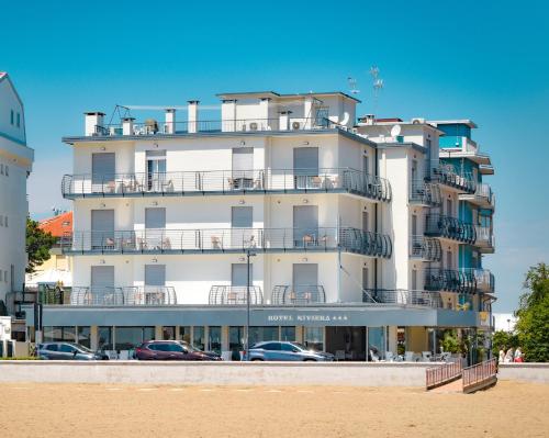a building on the beach next to the beach at Hotel Riviera in Caorle