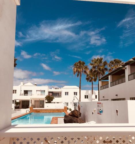 a view of the pool from the balcony of a house at Romantic Casa del Mar in Costa Teguise