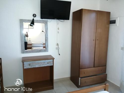 a living room with a mirror and a dresser at Avra Ηouse in Kriopigi