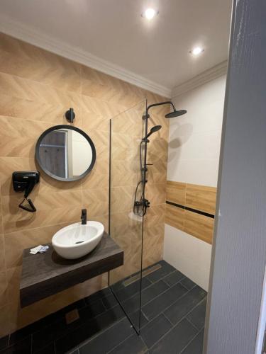 a bathroom with a sink and a mirror at Апартаменти Генезис Ахтопол in Ahtopol