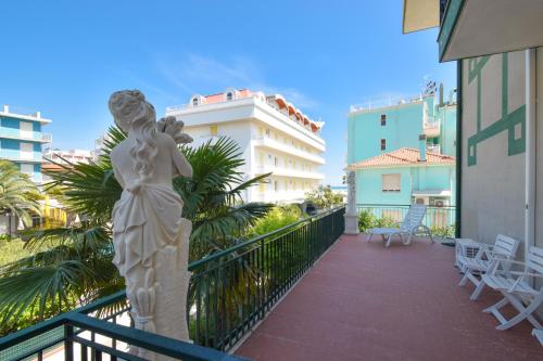 a statue of a woman on the balcony of a building at Hotel Janeiro in Caorle