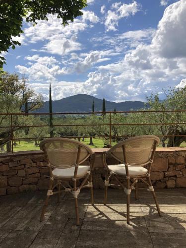 two chairs sitting next to a table on a patio at Les Hauts de Diane, CUERS var in Cuers