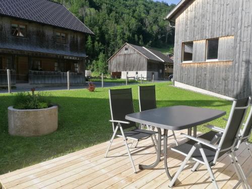 a table and two chairs on a wooden deck at Kanis 80 in Schnepfau