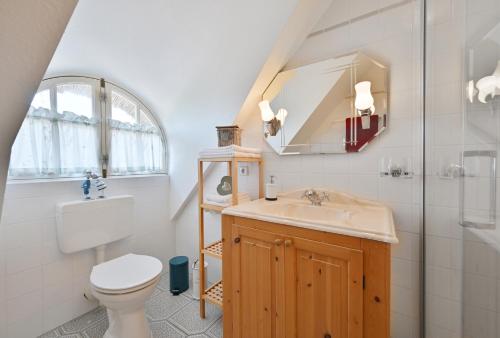 a bathroom with a toilet and a sink and a mirror at Landhaus Vilmnitz - Wohnung 1 in Vilmnitz