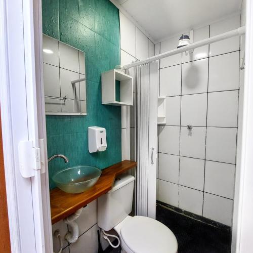 a bathroom with a white toilet and a sink at Hostel Brooklin in São Paulo