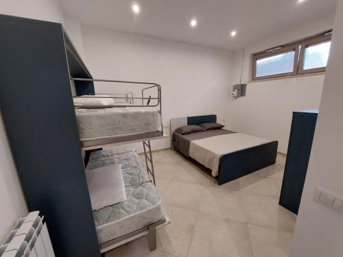 En eller flere senge i et værelse på Alloggio Turistico Via Appia n 1763