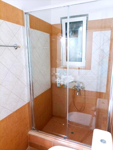 a shower with a glass door in a bathroom at Gythio Seaside Villa Dimitrios - Panoramic View in Gythio