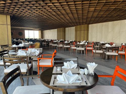 a dining room with tables and chairs and tablesktop at Apec Mandala Phú Yên Hương Giang Condotel in Liên Trì (3)
