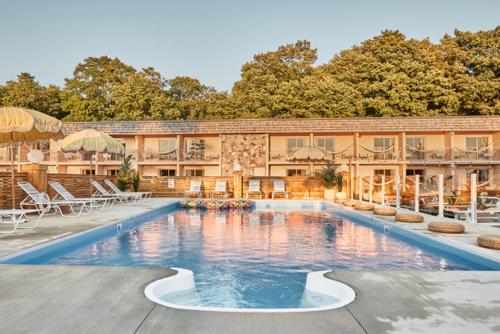 a large swimming pool in front of a building at The June Motel in Sauble Beach