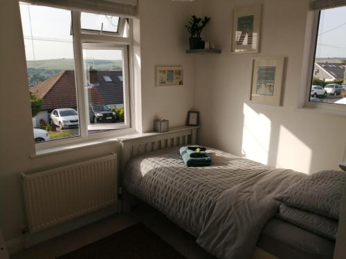 a bedroom with a bed with a stuffed animal on it at South Downs View in Brighton & Hove